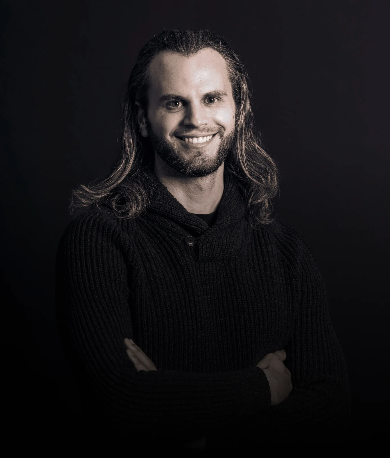 Alex Boyd, arms crossed, smiling at the camera.